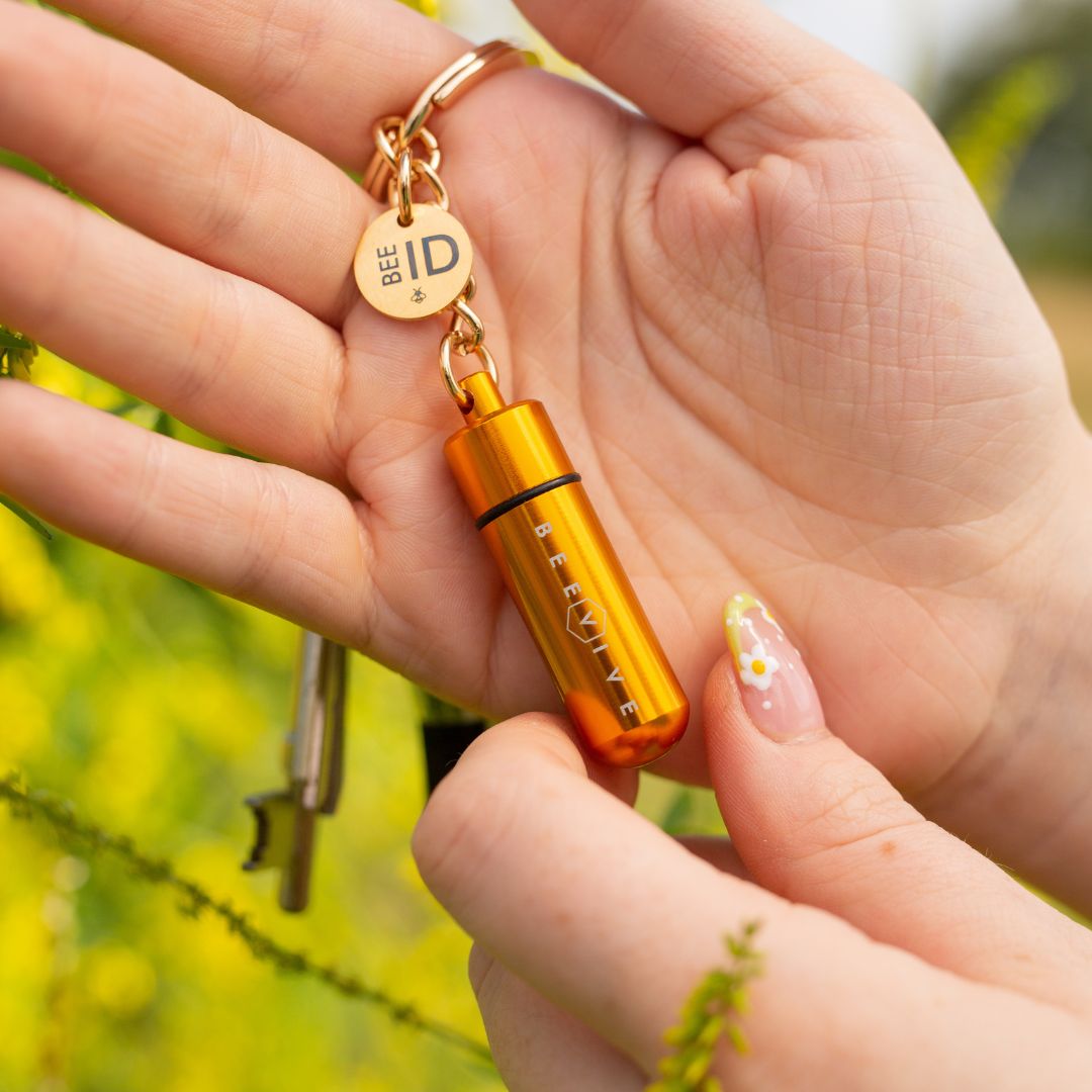 holding a limited edition gold bee revival kit and bee id keyring