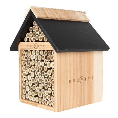 side angle of bee hotel 2.0 out of its cardboard sleeve showing beevive logo in wood available from beevive.com