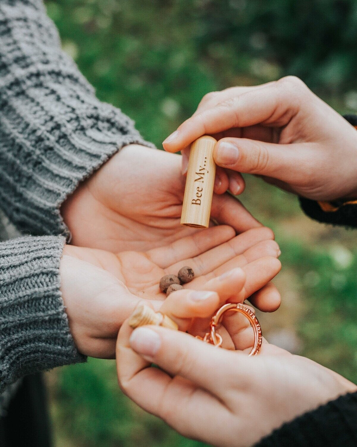 three seedballs being emptied from the bamboo bee revival kit into cupped hands