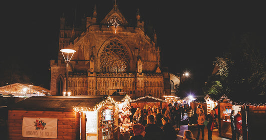exeter christmas market at night with exeter cathedral in the background