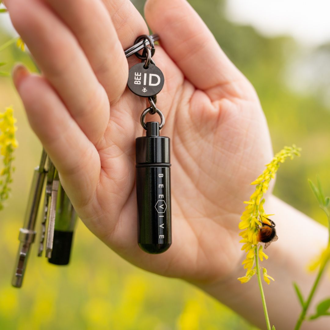 holding a limited edition black bee revival kit and bee id keyring