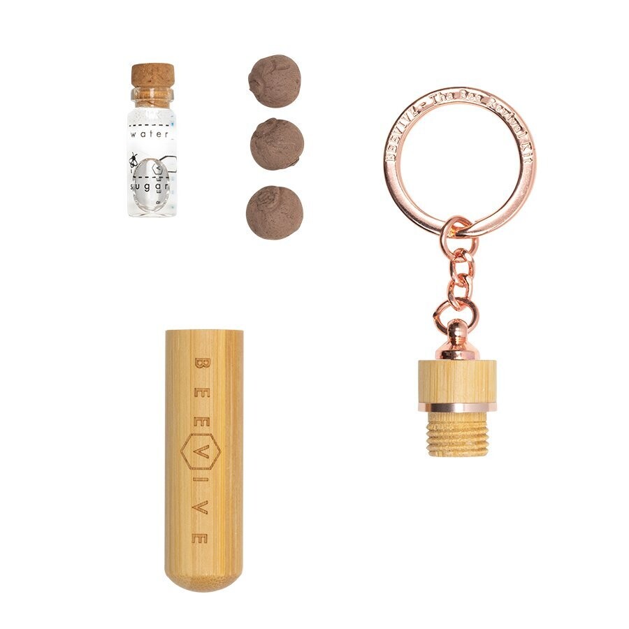 rose gold bamboo bee revival kit contents showing replacement bottle and seedballs and top is unscrewed